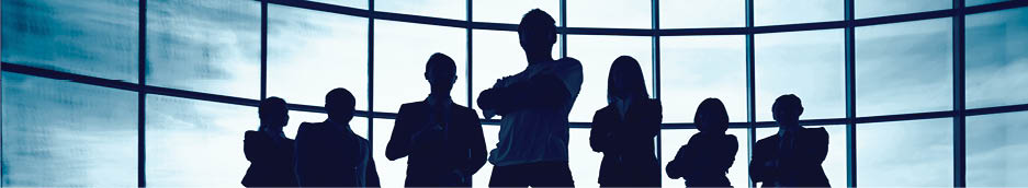 Business team standing against window with leader in front